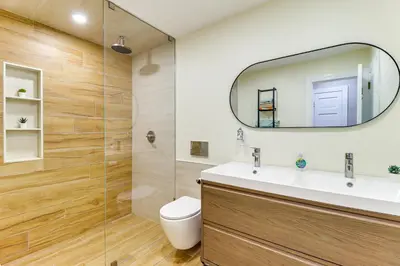 a bathroom with a toilet and a sink and a mirror at 5 Mi to Jack Frost Skiing Walkable Family Home in Lake Harmony