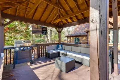 a screened in porch with a bench and a grill at 5 Mi to Jack Frost Skiing Walkable Family Home in Lake Harmony