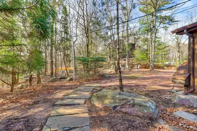 a stone walkway in the woods with a rock at 5 Mi to Jack Frost Skiing Walkable Family Home in Lake Harmony