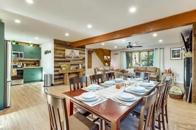 a dining room and kitchen with a table and chairs at 5 Mi to Jack Frost Skiing Walkable Family Home in Lake Harmony