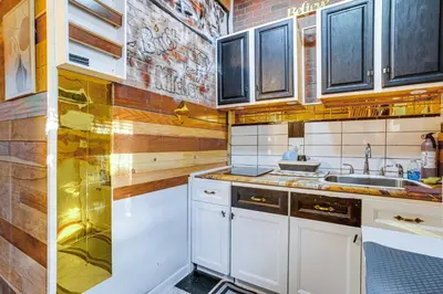 a kitchen with white cabinets and a sink at Upper Clinton Hill Studio! Walk to Eats and Shops in Newark