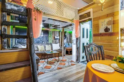 a living room with a bunk bed and a table at Upper Clinton Hill Studio! Walk to Eats and Shops in Newark
