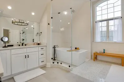 a white bathroom with a tub and a shower at Pond and Gazebo Expansive Hudson Valley Escape! in Goshen