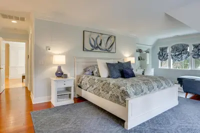 a bedroom with a large bed with blue pillows at Pond and Gazebo Expansive Hudson Valley Escape! in Goshen