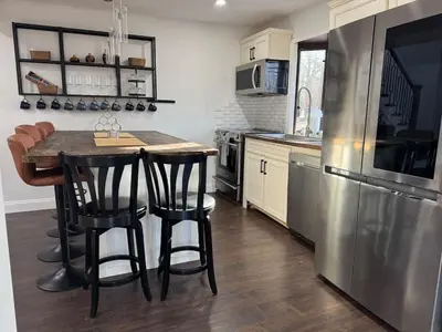 a kitchen with a table and a refrigerator at Mountain View family escape in Albrightsville