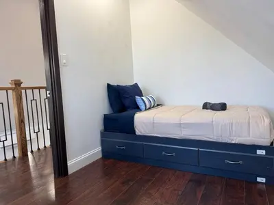 a bedroom with a bed with blue drawers and a mirror at Mountain View family escape in Albrightsville