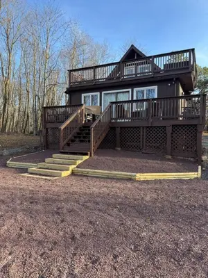 a large house with a deck and stairs at Mountain View family escape in Albrightsville