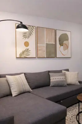 a living room with a couch and some pictures on the wall at Hip NYC Hideaway in Lively East Village in New York