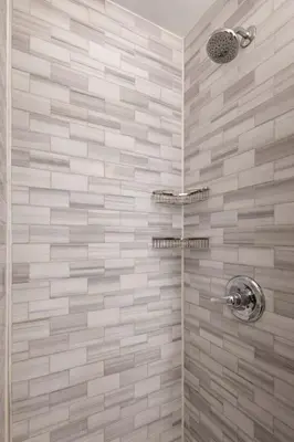 a bathroom with a shower with beige tiles at Hip NYC Hideaway in Lively East Village in New York