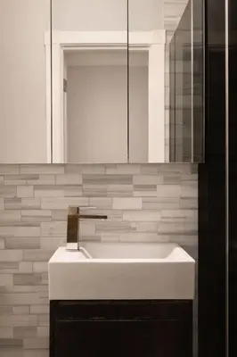 a bathroom with a white sink and a mirror at Hip NYC Hideaway in Lively East Village in New York
