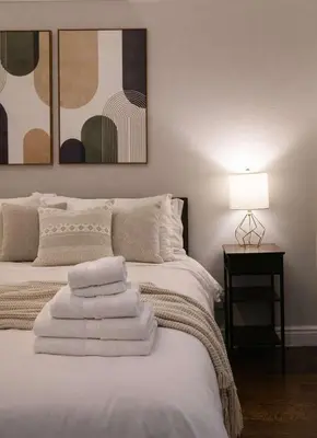 a bedroom with a bed with towels on it at Hip NYC Hideaway in Lively East Village in New York