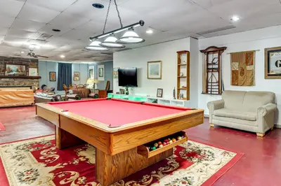 a living room with a pool table at 4 Mi to Mauch Chunk Lake Spacious Apt with Bar! in Summit Hill