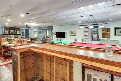 a large room with a pool table in the middle at 4 Mi to Mauch Chunk Lake Spacious Apt with Bar! in Summit Hill