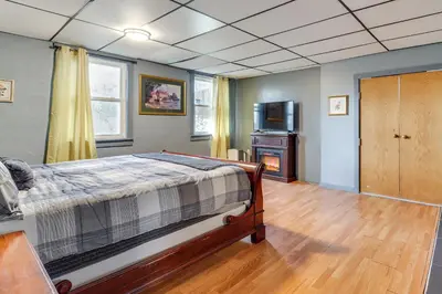a bedroom with a bed and a television in it at 4 Mi to Mauch Chunk Lake Spacious Apt with Bar! in Summit Hill