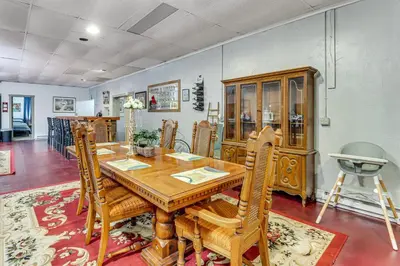 a dining room with a wooden table and chairs at 4 Mi to Mauch Chunk Lake Spacious Apt with Bar! in Summit Hill