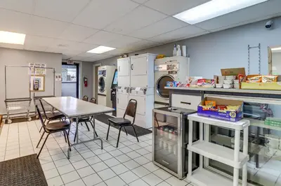 a kitchen with a table and chairs in a room at 4 Mi to Mauch Chunk Lake Spacious Apt with Bar! in Summit Hill