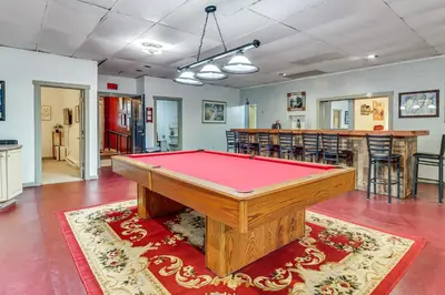 a pool table in the middle of a room at 4 Mi to Mauch Chunk Lake Spacious Apt with Bar! in Summit Hill