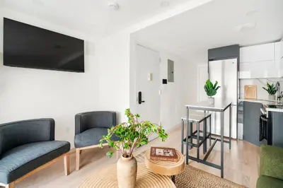 a living room with two chairs and a table at 22nd Sleek Modern 1BR Gramercy in New York