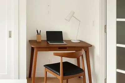 a desk with a laptop and a lamp on it at 22nd Sleek Modern 1BR Gramercy in New York