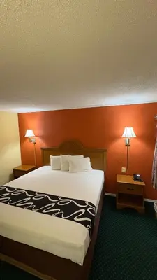 a hotel room with a large bed and two lamps at Red Bank Inn