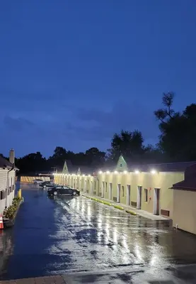 a long row of buildings with lights on them at Red Bank Inn