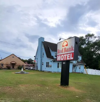 a red bank motel sign in front of a house at Red Bank Inn