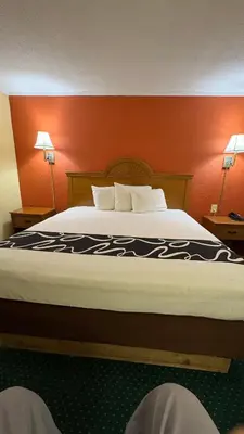a large bed in a hotel room with two lamps at Red Bank Inn