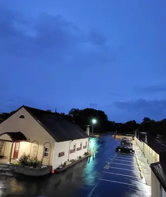 a parking lot with cars parked outside of a building at Red Bank Inn