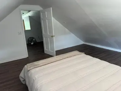 a white bedroom with a bed in a room at 3 Loft Bedrooms Gazebo Patio Lounge in Roselle