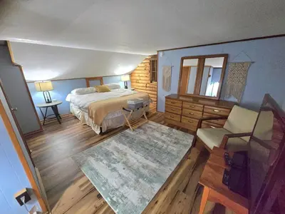 a bedroom with a bed and a table and a chair at 4BR Cabin by the Lake with Hot Tub, Game Room, Fire Pit in Lake Harmony