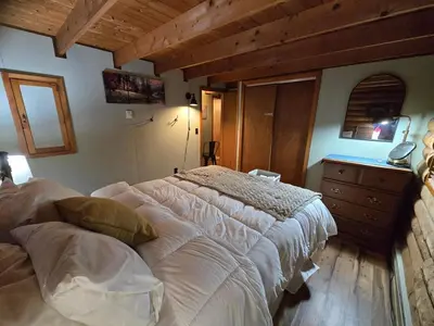 a bedroom with a large bed and a dresser at 4BR Cabin by the Lake with Hot Tub, Game Room, Fire Pit in Lake Harmony