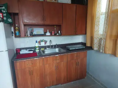 a kitchen with wooden cabinets and a sink at 1052grovest #3 in Irvington