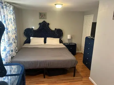 a bedroom with a bed with a black headboard at 1052grovest #3 in Irvington