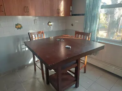 a wooden table and chairs in a kitchen at 1052grovest #3 in Irvington