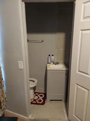 a bathroom with a toilet and a sink at 1052grovest #3 in Irvington
