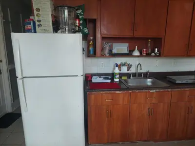 a kitchen with a white refrigerator and a sink at 1052grovest #3 in Irvington