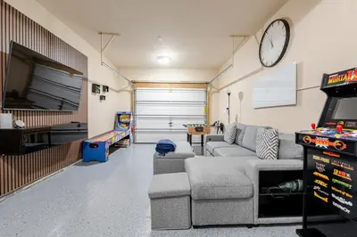 a living room with a couch and a tv at Boulders Retreat Hot Tub Sauna Game Room Fire Pit in Tobyhanna
