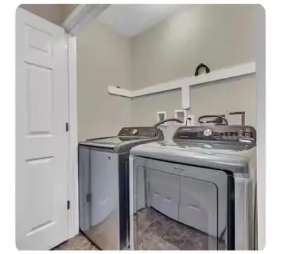 a kitchen with a stove and a washer and dryer at Boulders Retreat Hot Tub Sauna Game Room Fire Pit in Tobyhanna