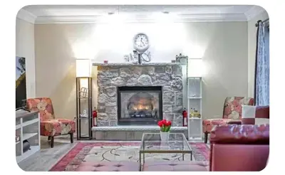 a living room with a fireplace with a couch and chairs at Boulders Retreat Hot Tub Sauna Game Room Fire Pit in Tobyhanna