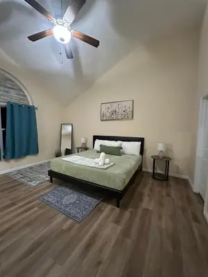 a bedroom with a bed and a ceiling fan at Boulders Retreat Hot Tub Sauna Game Room Fire Pit in Tobyhanna