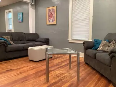 a living room with two couches and a glass table at Pleasant, Comfortable PR Near Vestal NY in Johnson City