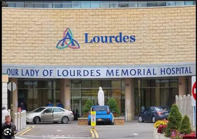 a lou parcels hospital with cars parked in a parking lot at Binghamton Hospitals Private Room Shared Spaces Trades Medical Staff Welcom in Binghamton