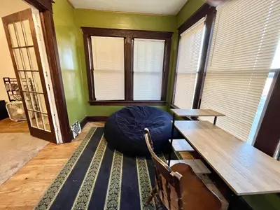 a room with a table and a bean bag chair at NightShiftReady Binghamton Trades Nurses Welcome Private Room in Shared Apartment in Binghamton