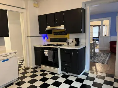 a kitchen with black appliances and a checkered floor at Affordable for Crews Binghamton Close to Job Sites in Binghamton