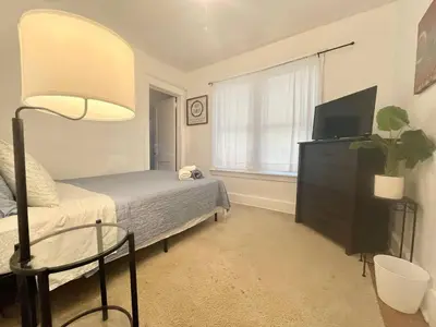 a bedroom with a bed and a table and a lamp at Affordable for Crews Binghamton Close to Job Sites in Binghamton