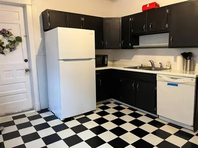 a white refrigerator in a kitchen with a checkered floor at Affordable for Crews Binghamton Close to Job Sites in Binghamton