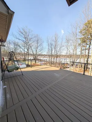 a deck with a swing and a playground at Home in Mount Pocono - Sauna & Lakefront in Pocono Summit