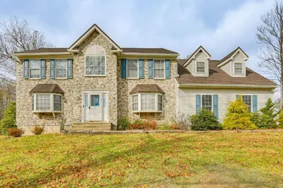 a large brick house with a yard at Hike, Ski and Game Spacious Poconos Home with Yard in Tobyhanna