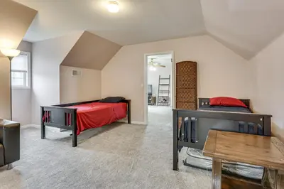 a bedroom with two beds and a table at Hike, Ski and Game Spacious Poconos Home with Yard in Tobyhanna
