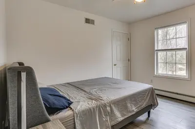 a bedroom with a bed and a window at Hike, Ski and Game Spacious Poconos Home with Yard in Tobyhanna